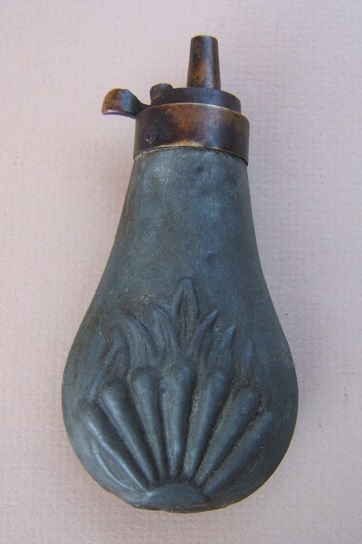 A GOOD MID-19th CENTURY SMALL-SIZED EMBOSSED ZINC POWDER FLASK, ca. 1850 view 1