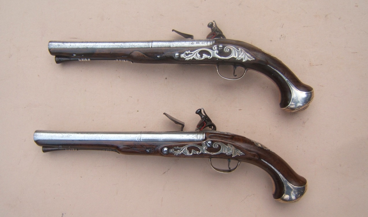 A VERY FINE+/MUSEUM GRADE PAIR OF EARLY 18TH CENTURY/FRENCH & INDIAN WAR PERIOD ENGLISH SILVER MOUNTED FLINTLOCK HOLSTER PISTOLS, by 