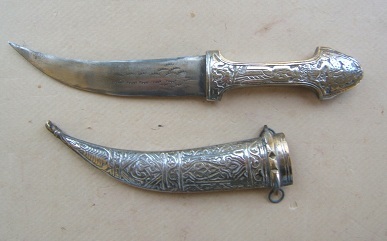 A 20th CENTURY NICKEL-SILVER MOUNTED ARABIAN TOURIST TYPE JAMBIYA WITH EMBOSSED AND CHASED SCABBARD, ca. 1970 view 1