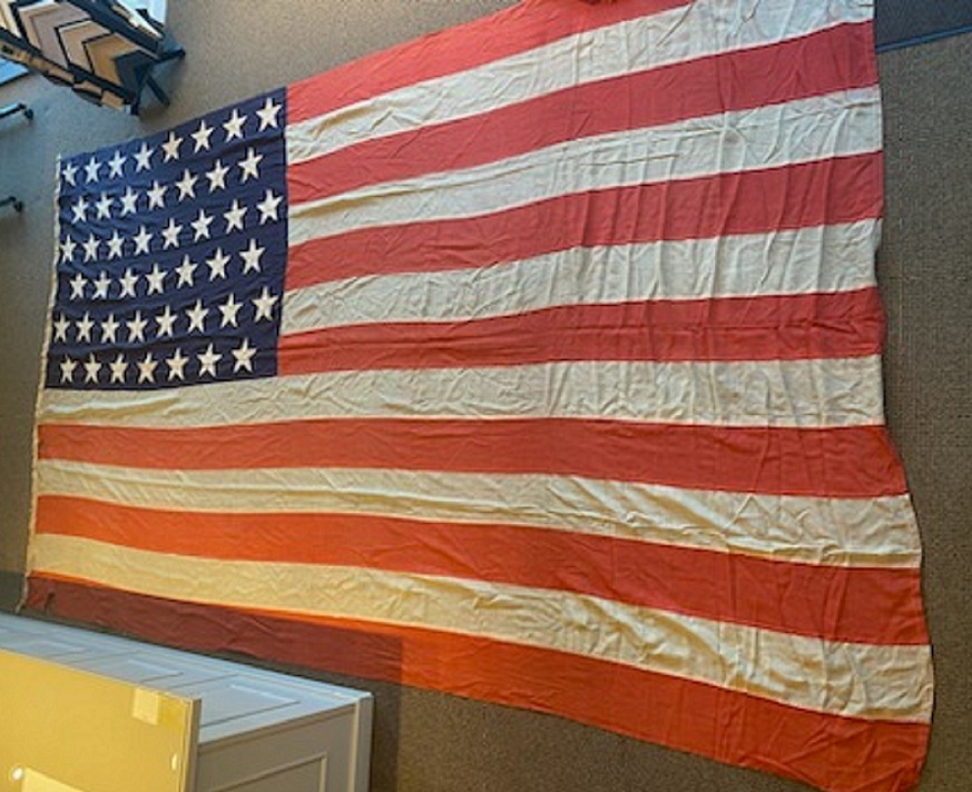 A RARE WORLD WAR II ISSUED LARGE-SIZE & I'D 48-STAR AMERICAN FLAG, FLOWN ON THE TRANSPORT SHIP 